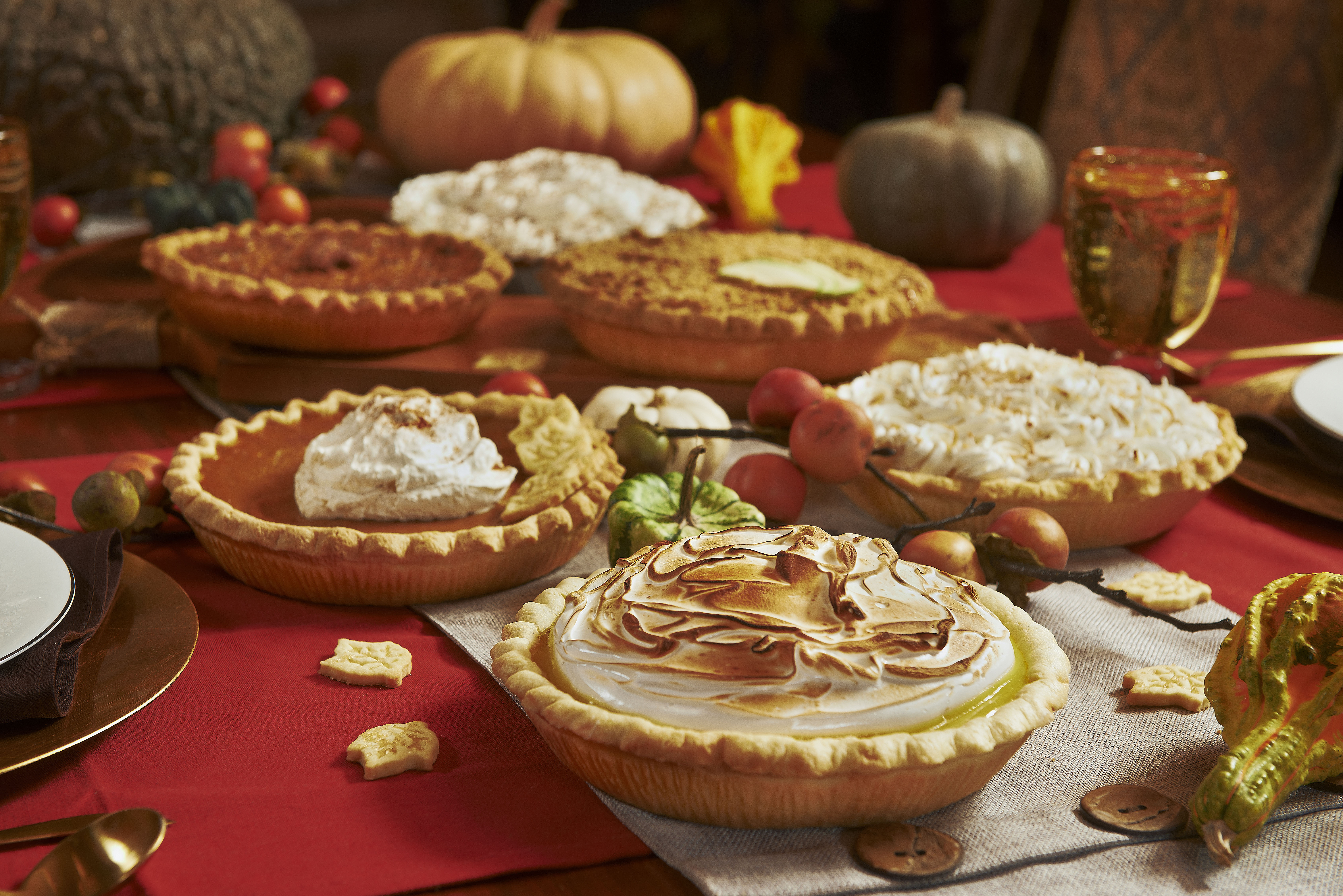 Multiple pies on pretty table. 